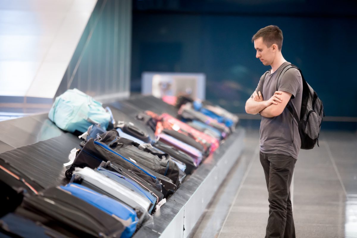 a man waiting at baggage claim